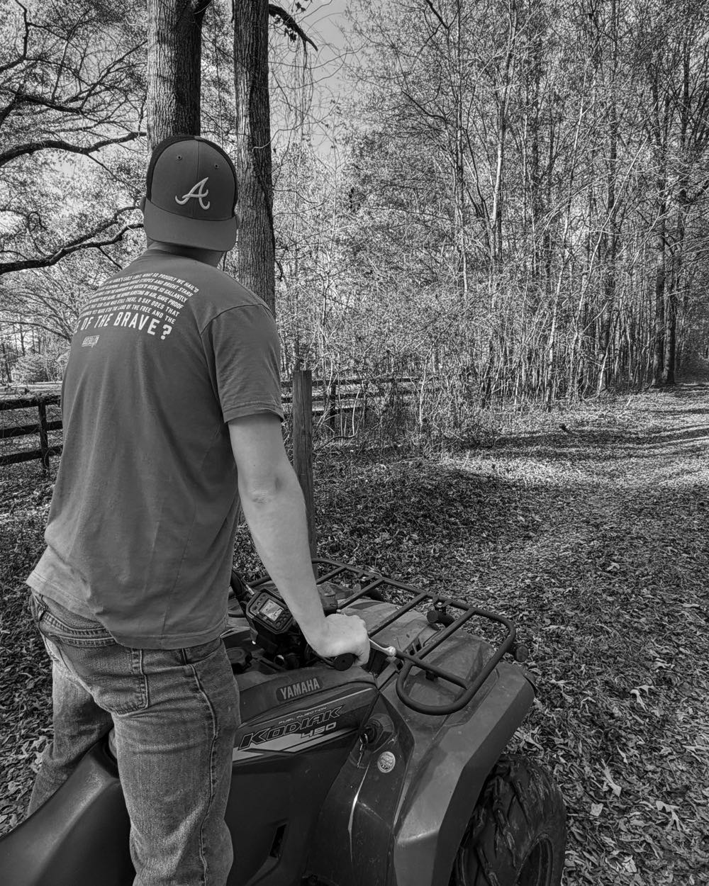 Cody Mullin on a four-wheeler, looking down a wooded trail